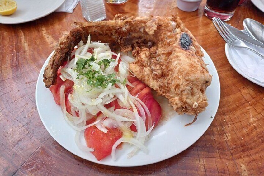 Deep fried hake (cod) with the traditional "Chilean salad" (tomato, onion and coriander)