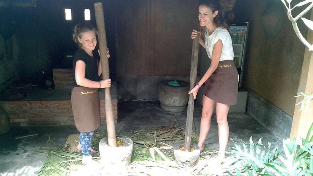 girls working in barn in bali