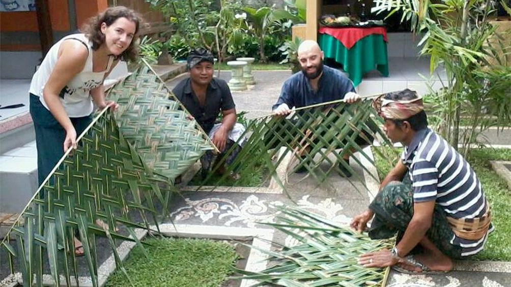 people weaving grasses in bali