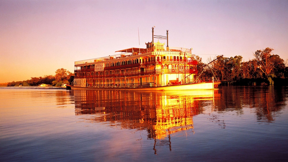 Show item 1 of 5. Boat on the waters of the Murray River Wetlands at sunset in South Australia