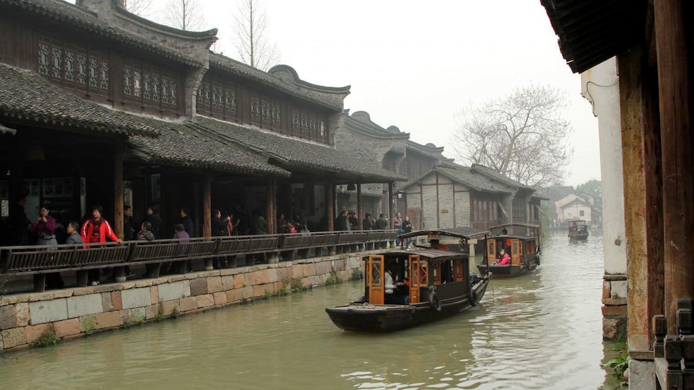 covered boats navigating the narrow waterways in Wuzhen