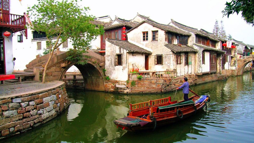 woman in ferry in canal in Suzhou, China