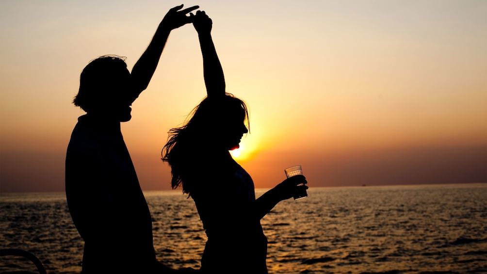 Couple dancing on the Sunset Catamaran Cruise in Negril