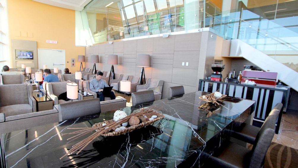 Show item 4 of 5. Couch area inside the Plaza Premium Lounge at Edmonton International Airport