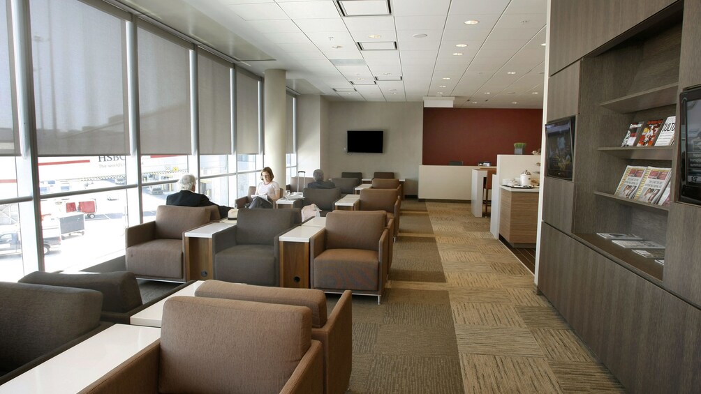 Seating area and view outside the window at the Plaza Premium Lounge at Toronto Pearson International Airport