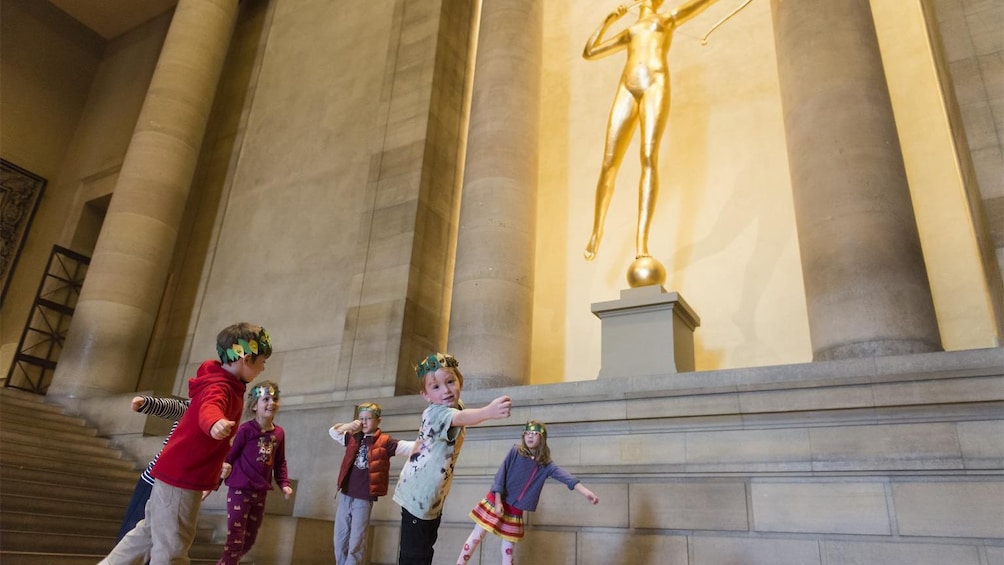 Children emulating a statue at the Philadelphia Museum of Art