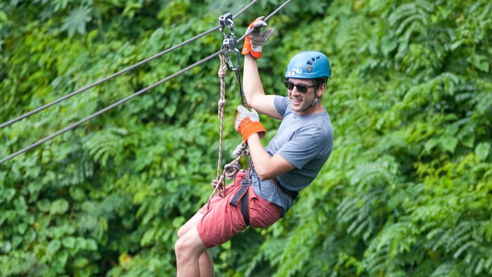 man in sunglasses ziplining in Antigua