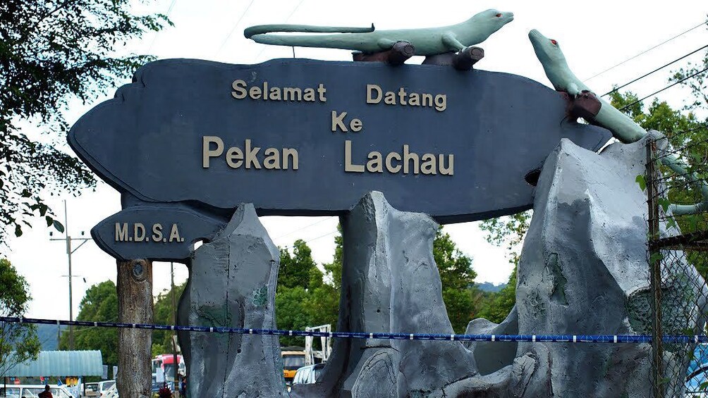 lizard sculptures on top of large sign in Malaysia