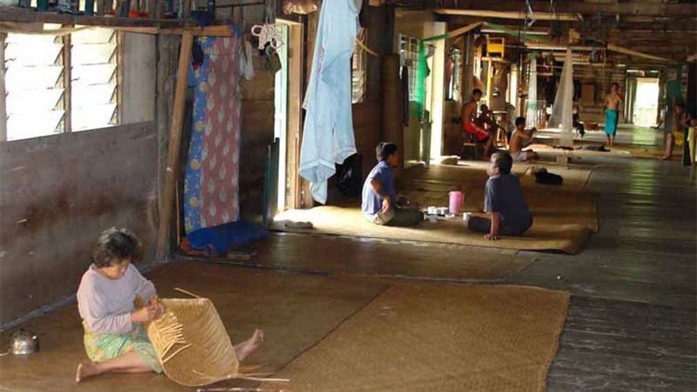 locals resting and weaving straw goods in Malaysia