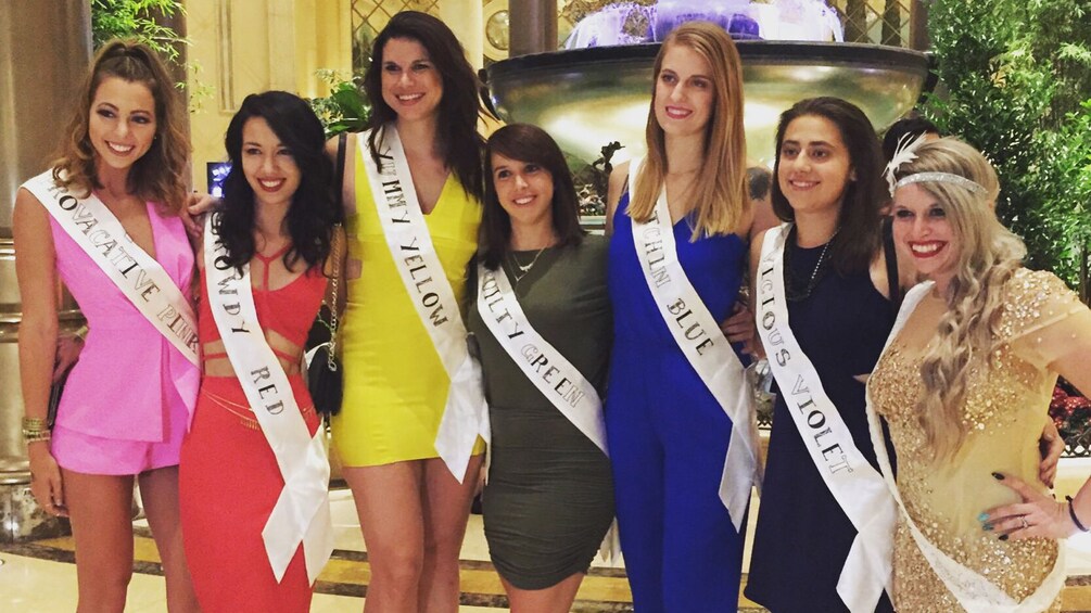 Women dressed up in different colored evening gowns