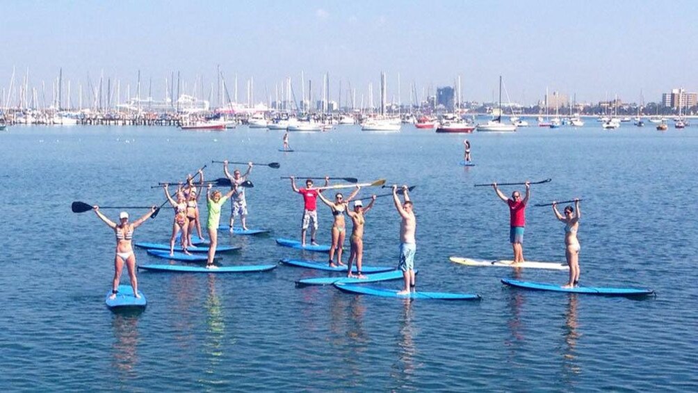 Group stand on paddle boards 