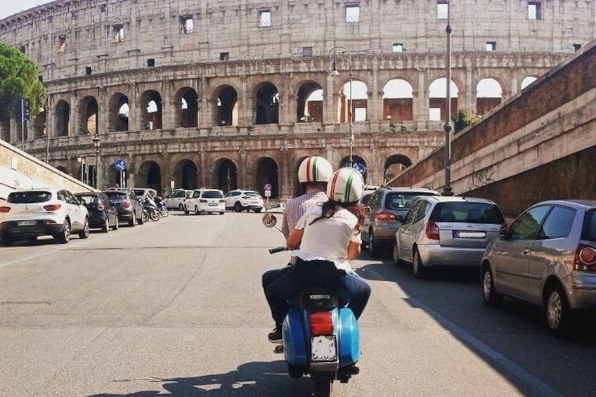 Riding Vespa at the Front of Its Majesty the Colosseum