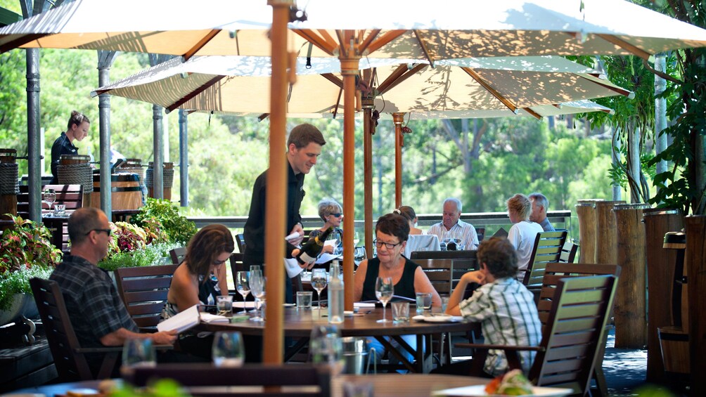 Group of people at outdoor wine tasting during the day.