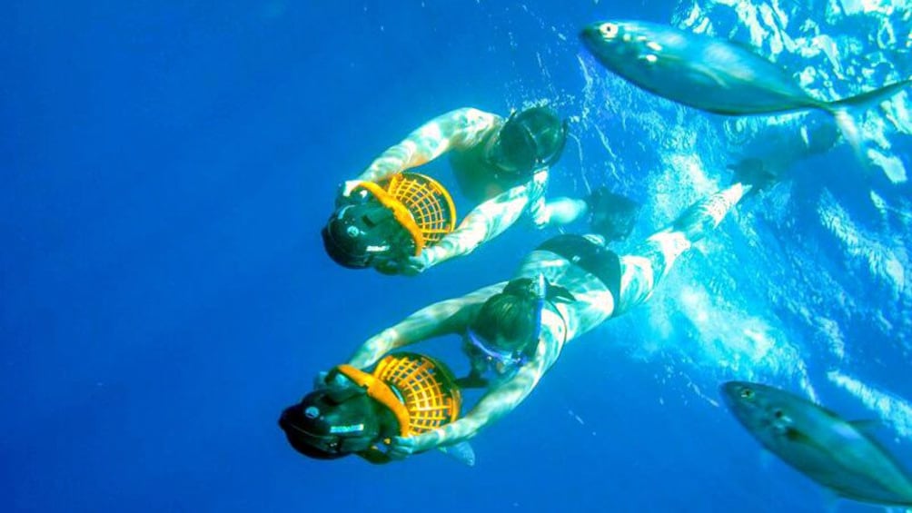 Swimming couple with personal water propellers in Los Cabos