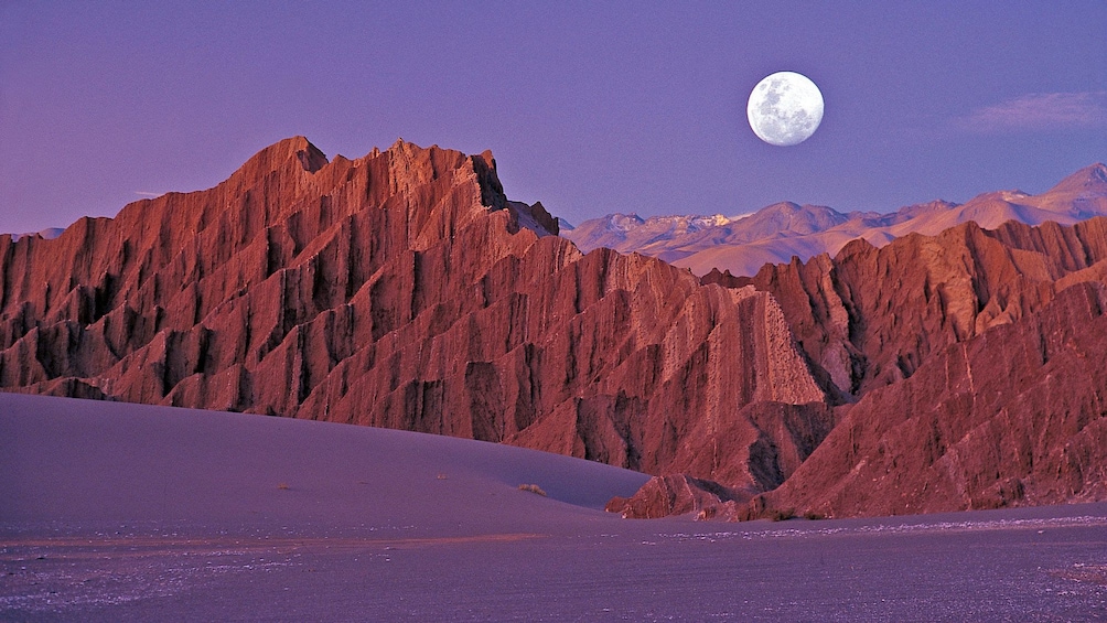 Moon rising over the mountains surrounding Moon Valley in Chile