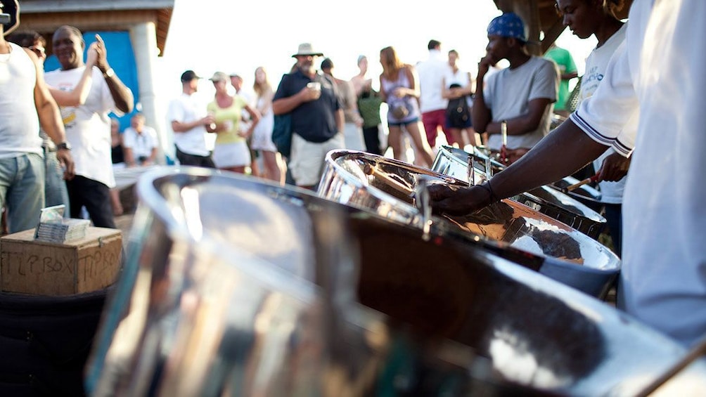 Show item 5 of 7. People dancing to steel drum music being played in Antigua
