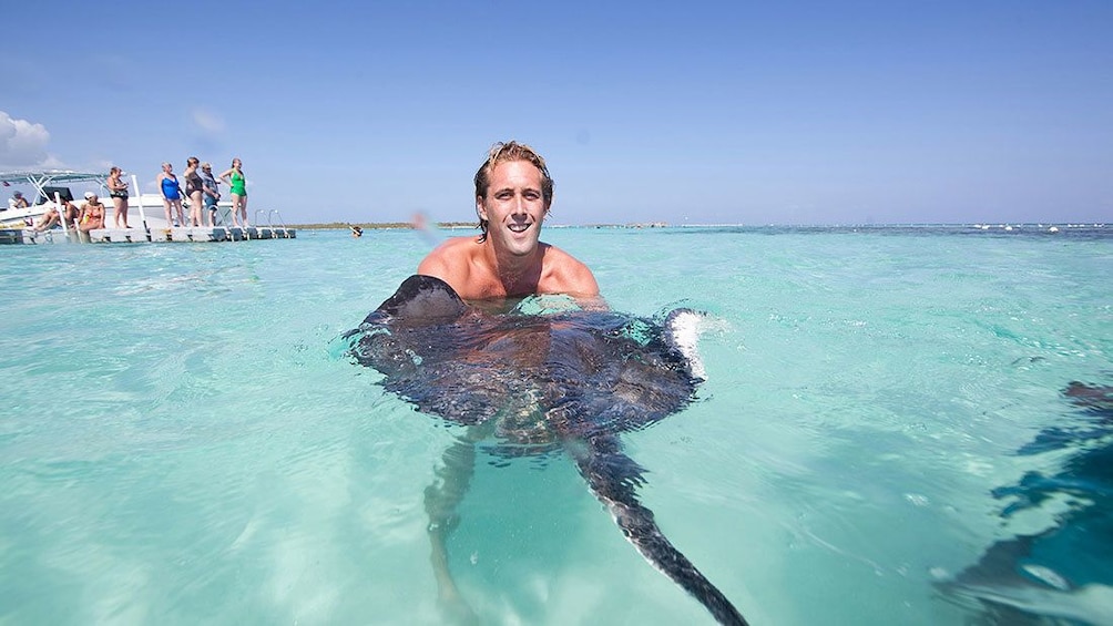 A man holding a stingray in Antigua