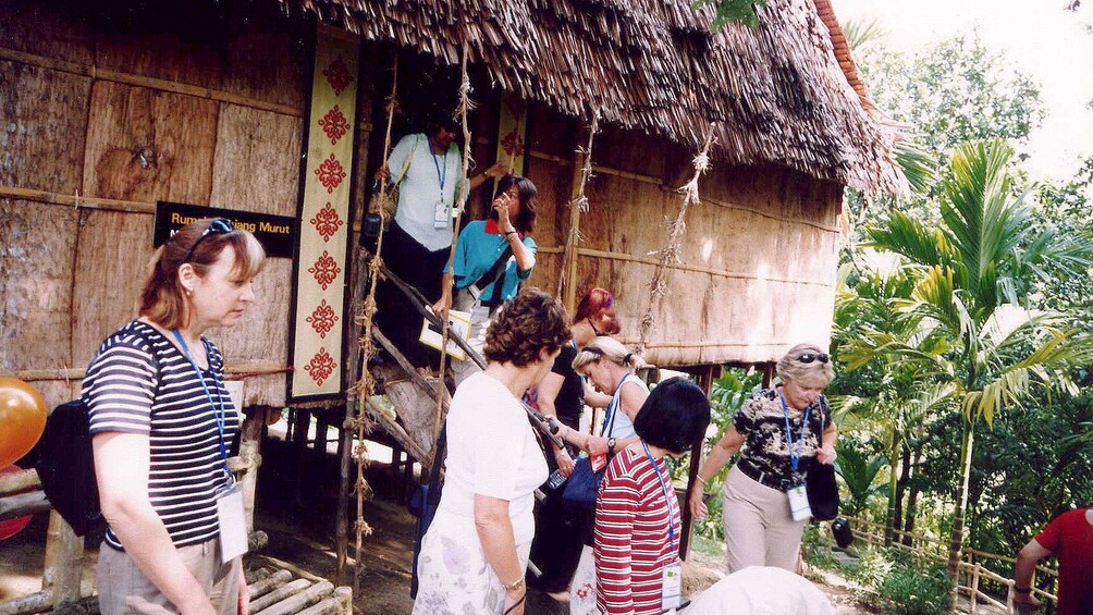 visitors walking through a small hut in Kota Kinabalu