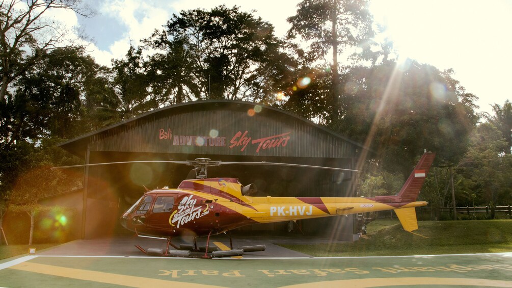 Tampilkan item 4 dari 5. a helicopter sitting near the hanger in Bali