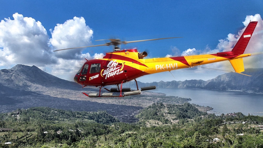 Tampilkan item 1 dari 5. helicopter flying over the green landscape in Bali