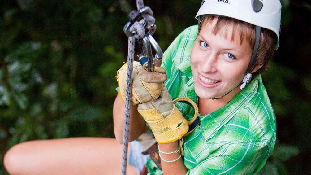 ziplining woman holding on to the harness in Saint Lucia