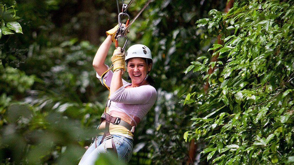 woman in white helmet ziplining in Saint Lucia