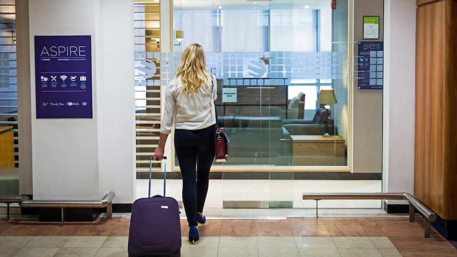 woman entering the Aspire airport lounge