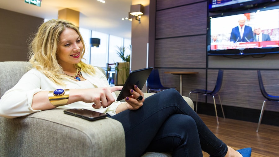 woman reading her tablet at the airport lounge