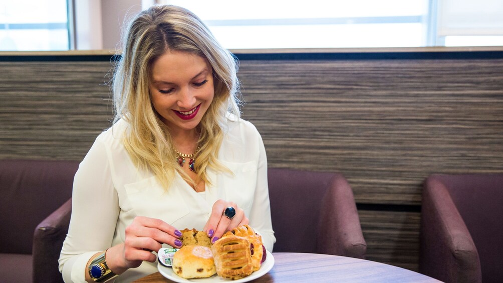 Show item 3 of 5. woman enjoying pastries at the airport lounge