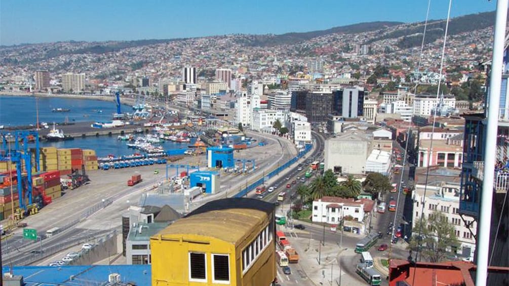 Aerial view of city with small trolly going down tracks.