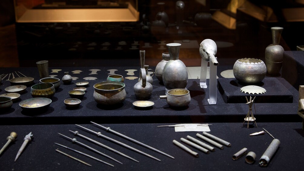 Ornamental clay pots and tools on display