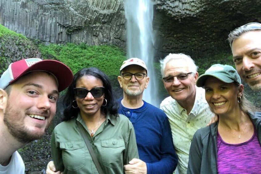 Happy customers in front of waterfalls in Columbia River Gorge