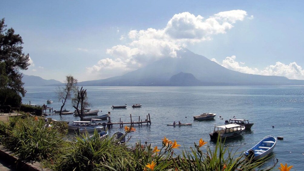 Shore of Lake Atitlan with a volcano in the distance