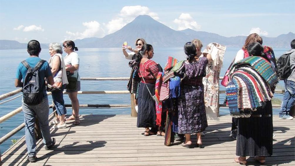 Tourists taking pictures of the Lake Atitlan from Panajachel in Guatemala 