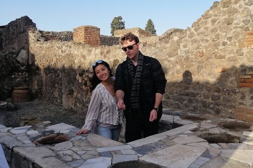 Tourists by a thermopolium Herculaneum