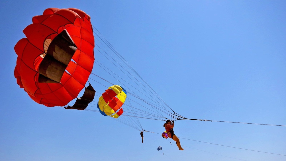Show item 2 of 5. parasailing close to other parasailers in Bali