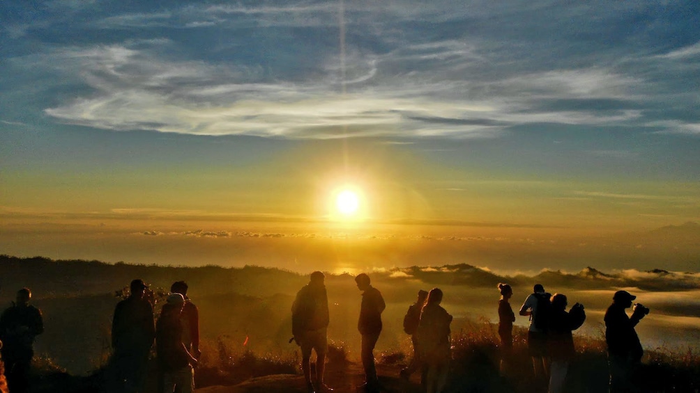 group on Mount Batur observing the sunrise in Indonesia