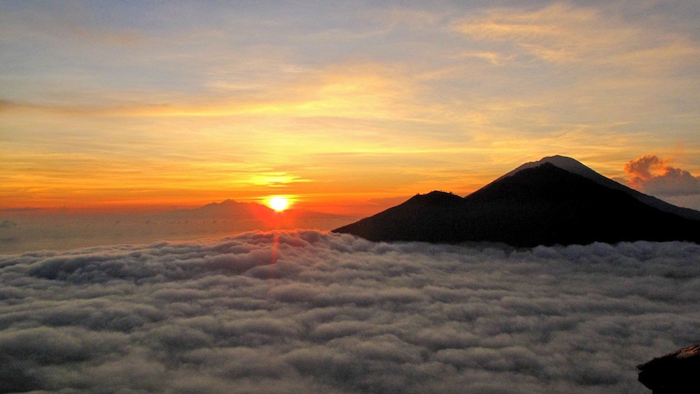 un rising above the clouds in Indonesia