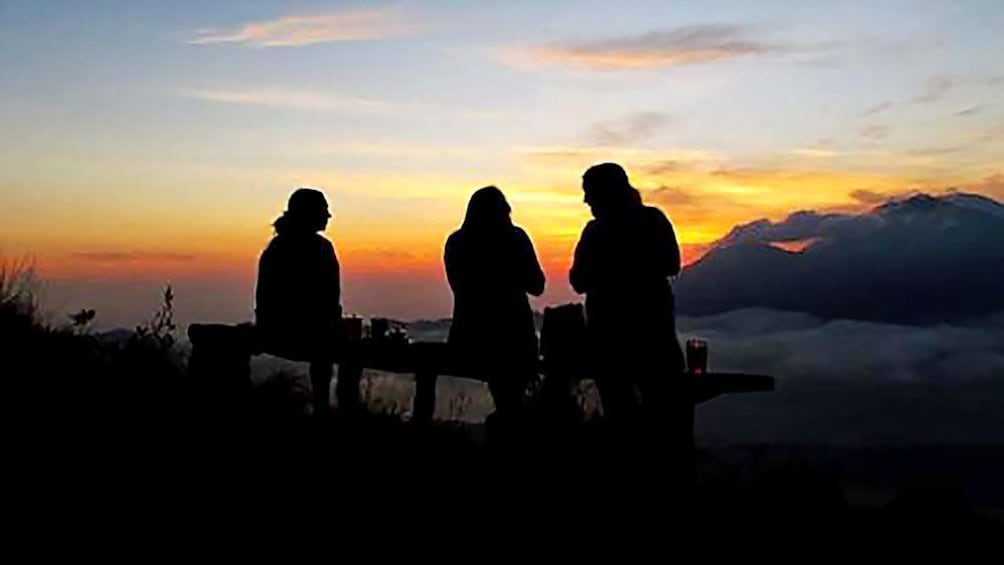 bundled group viewing the sunset from Mount Batur in Indonesia