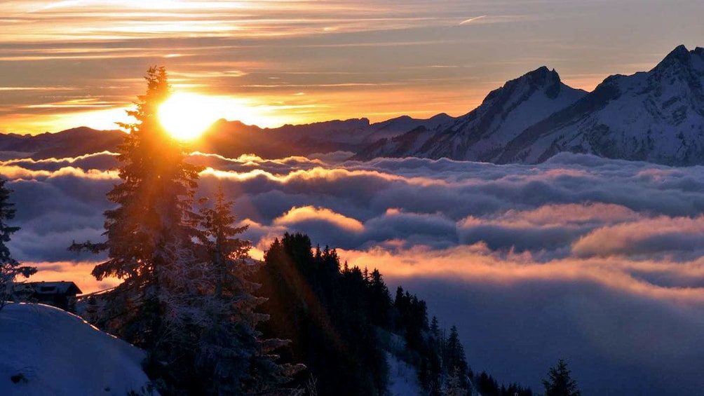 sun rising above the mountains and low hanging clouds in Indonesia