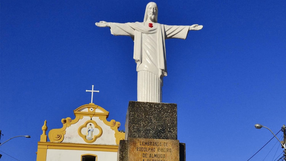 Statue of Christ and church in Arraial D'Ajuda