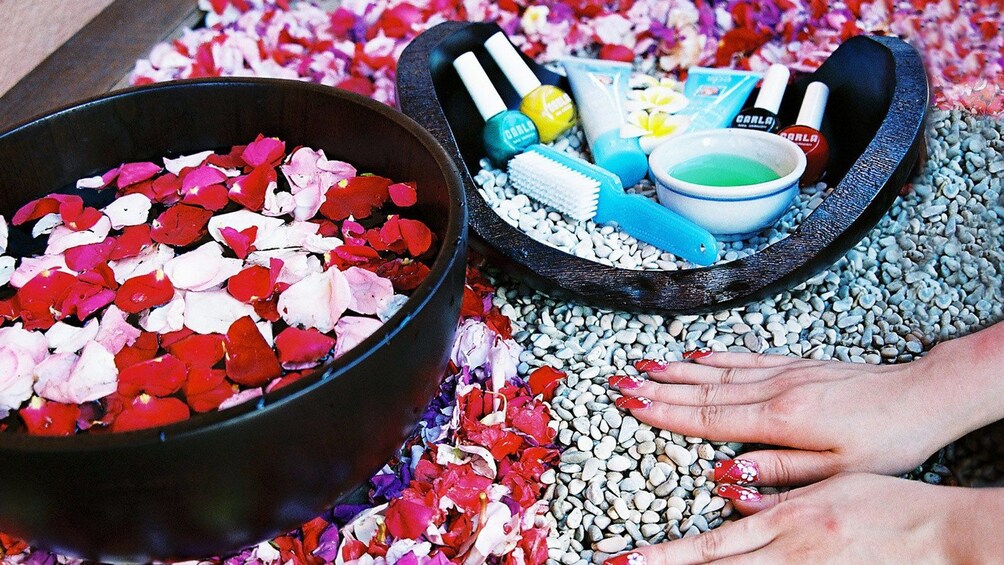 flower peddles, small pebbles, and beauty products at the spa in Bali