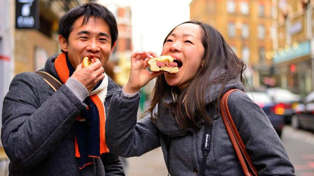 Couple enjoying sandwiches on  London's artsy East End