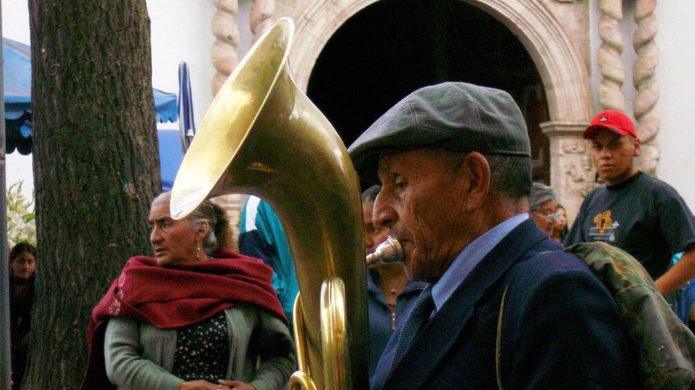 Street performer playing the tuba in Cuenca