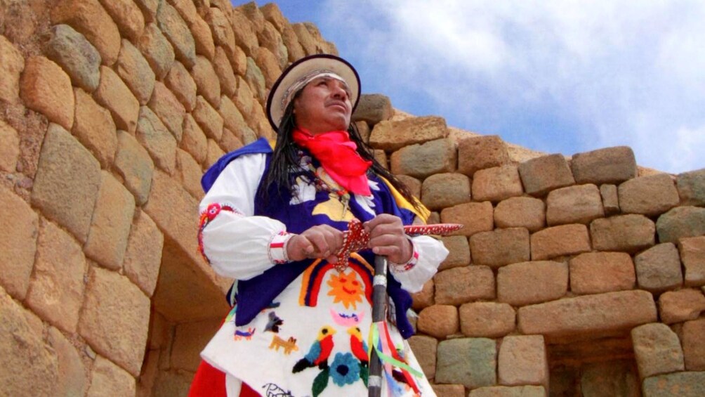 Man dressed in traditional Inca clothing at the ruins of Ingapirca near Cuenca