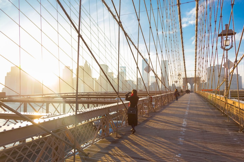 On Brooklyn Bridge footpath with setting sun