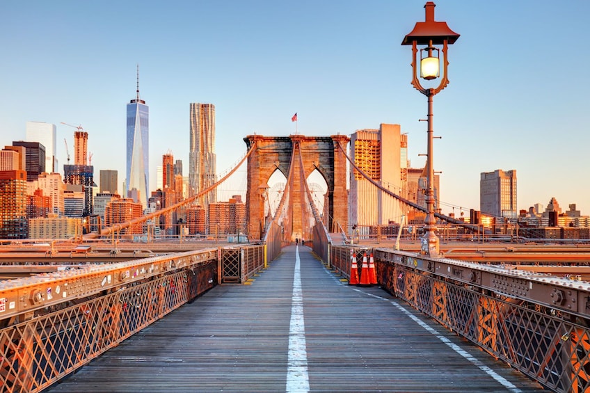 Brooklyn Bridge footpath to Manhattan at sunset