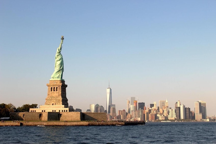 Wide shot of the Statue of Liberty with lower Manhattan in background