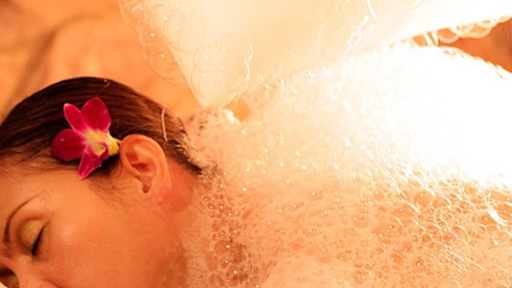 Close up of woman receiving bath treatment at spa.