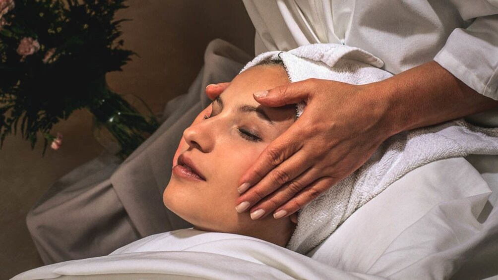 Close up of woman receiving facial massage.